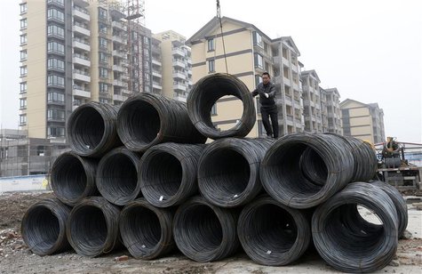 A labourer works on coils of steel at the construction site of a residential compound in Jiaxing, Zhejiang province, January 16, 2013. REUTE A labourer works on coils of steel at the construction site of a residential compound in Jiaxing, Zhejiang province, January 16, 2013. REUTE