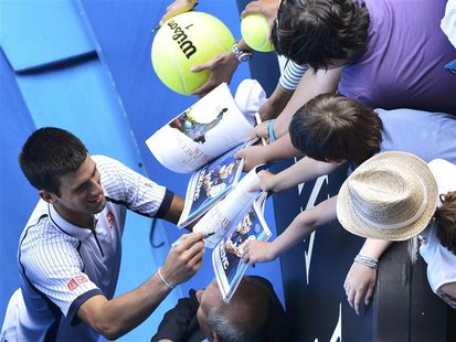 Novak Djokovic of Serbia signs autographs after defeating Radek Stepanek of Czech Republic in their men's singles match at the Australian Op Novak Djokovic of Serbia signs autographs after defeating Radek Stepanek of Czech Republic in their men's singles match at the Australian Op
