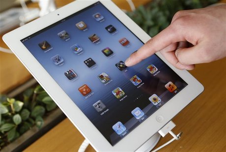 A visitor tries Apple Inc's iPad at an electronics store in central Seoul January 18, 2013. Sharp Corp has nearly halted production of 9.7-i A visitor tries Apple Inc's iPad at an electronics store in central Seoul January 18, 2013. Sharp Corp has nearly halted production of 9.7-i