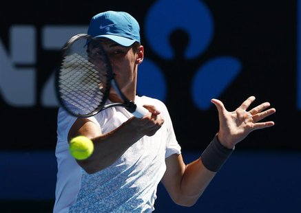 Bernard Tomic of Australia hits a return to Daniel Brands of Germany during their men's singles match at the Australian Open tennis tourname Bernard Tomic of Australia hits a return to Daniel Brands of Germany during their men's singles match at the Australian Open tennis tourname
