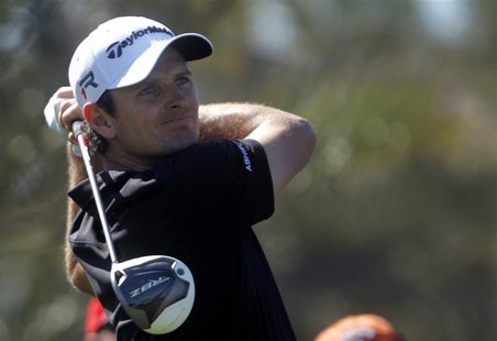 Justin Rose of England watches his shot from the ninth tee during the second round of the Abu Dhabi Golf Championship at the Abu Dhabi Golf Justin Rose of England watches his shot from the ninth tee during the second round of the Abu Dhabi Golf Championship at the Abu Dhabi Golf