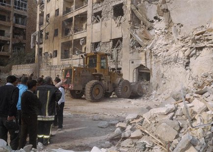 Rubble is removed from the entrance of a damaged building after a large blast hit a neighbourhood of the Syrian city of Aleppo January 18, 2 Rubble is removed from the entrance of a damaged building after a large blast hit a neighbourhood of the Syrian city of Aleppo January 18, 2