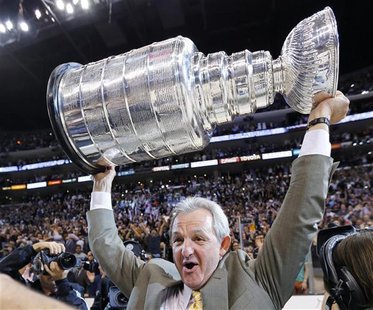 Los Angeles Kings head coach Darryl Sutter hoists the Stanley Cup after the Kings defeated the New Jersey Devils in Game 6 of the NHL Stanle Los Angeles Kings head coach Darryl Sutter hoists the Stanley Cup after the Kings defeated the New Jersey Devils in Game 6 of the NHL Stanle