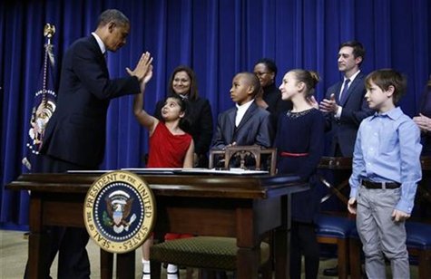 U.S. President Barack Obama high-fives eight-year-old Hinna Zejah after unveiling a series of gun control proposals during an event at the W U.S. President Barack Obama high-fives eight-year-old Hinna Zejah after unveiling a series of gun control proposals during an event at the W