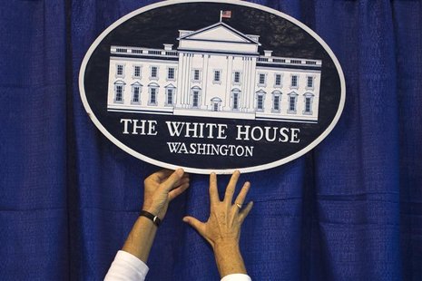 A volunteer adjusts a sign at the America Presidential Experience exhibit during the Democratic National Convention in Charlotte, North Caro A volunteer adjusts a sign at the America Presidential Experience exhibit during the Democratic National Convention in Charlotte, North Caro