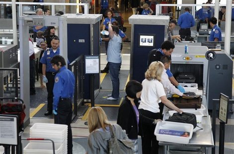 A man is screened with a backscatter x-ray machine as travellers go through a TSA security checkpoint in terminal 4 at LAX, Los Angeles Inte A man is screened with a backscatter x-ray machine as travellers go through a TSA security checkpoint in terminal 4 at LAX, Los Angeles Inte