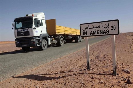 A truck passes by a road sign indicating In Amenas, about 100 km (60 miles) from the Algerian and Libyan border, where Islamist militants we A truck passes by a road sign indicating In Amenas, about 100 km (60 miles) from the Algerian and Libyan border, where Islamist militants we