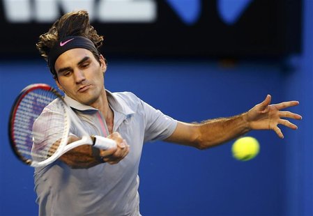 Roger Federer of Switzerland hits a return to Bernard Tomic of Australia during their men's singles match at the Australian Open tennis tour Roger Federer of Switzerland hits a return to Bernard Tomic of Australia during their men's singles match at the Australian Open tennis tour