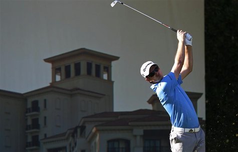 Justin Rose of England tees off at the 12th hole during the third round of the Abu Dhabi Golf Championship at the Abu Dhabi Golf Club Januar Justin Rose of England tees off at the 12th hole during the third round of the Abu Dhabi Golf Championship at the Abu Dhabi Golf Club Januar