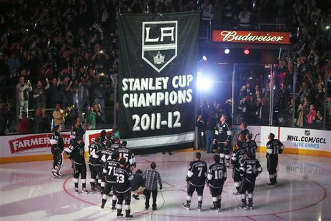 Los Angeles Kings players watch as their Stanley Cup championship banner is raised at the Staples Center before their NHL hockey game agains Los Angeles Kings players watch as their Stanley Cup championship banner is raised at the Staples Center before their NHL hockey game agains