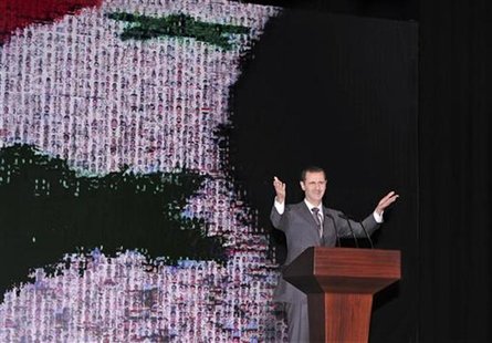 Syria's President Bashar al-Assad speaks at the Opera House in Damascus January 6, 2013, in this handout photograph released by Syria's nati Syria's President Bashar al-Assad speaks at the Opera House in Damascus January 6, 2013, in this handout photograph released by Syria's nati