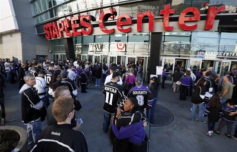 A Staples Center employee hugs a Los Angeles Kings fan as fans return for the first NHL game of the Kings' season against the Chicago Blackh A Staples Center employee hugs a Los Angeles Kings fan as fans return for the first NHL game of the Kings' season against the Chicago Blackh