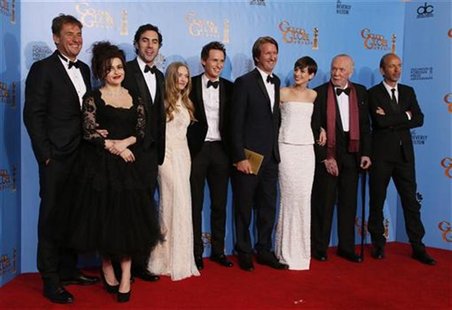 The Cast of "Les Miserables" (From L) producer Tim Bevan, Helena Bonham Carter, Sasha Baron Cohen, Amanda Seyfried, Eddie Redmayne, director The Cast of "Les Miserables" (From L) producer Tim Bevan, Helena Bonham Carter, Sasha Baron Cohen, Amanda Seyfried, Eddie Redmayne, director