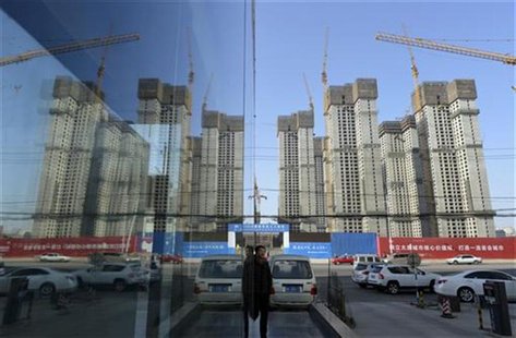 A construction site of a residential compound is reflected on the glass facades of a office building in Taiyuan, Shanxi province, January 15 A construction site of a residential compound is reflected on the glass facades of a office building in Taiyuan, Shanxi province, January 15