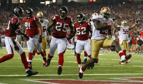 San Francisco 49ers running back Frank Gore (R) scores a touchdown past Atlanta Falcons strong safety William Moore (25) during the fourth q San Francisco 49ers running back Frank Gore (R) scores a touchdown past Atlanta Falcons strong safety William Moore (25) during the fourth q