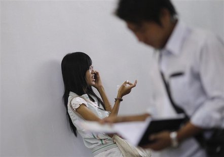 A girl talks on a mobile phone in a training school in Yangon January 19, 2013. REUTERS/Soe Zeya Tun A girl talks on a mobile phone in a training school in Yangon January 19, 2013. REUTERS/Soe Zeya Tun