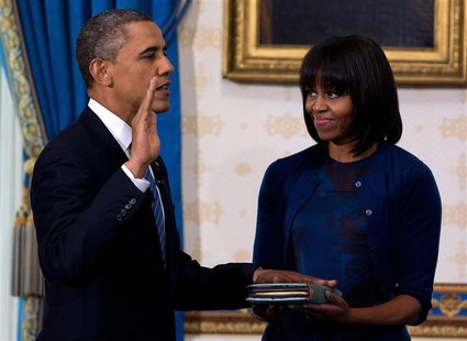 U.S. President Barack Obama takes the oath of office as frst lady Michelle Obama holds a bible during the official swearing-in ceremony at t U.S. President Barack Obama takes the oath of office as frst lady Michelle Obama holds a bible during the official swearing-in ceremony at t