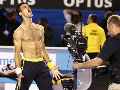 Novak Djokovic of Serbia celebrates defeating Stanislas Wawrinka of Switzerland in their men's singles match at the Australian Open tennis t Novak Djokovic of Serbia celebrates defeating Stanislas Wawrinka of Switzerland in their men's singles match at the Australian Open tennis t