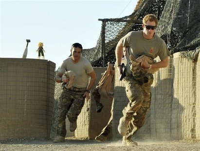 Britain's Prince Harry (R) races out from the VHR (very high ready-ness) tent with fellow crew, to scramble his Apache helicopter at Camp Ba Britain's Prince Harry (R) races out from the VHR (very high ready-ness) tent with fellow crew, to scramble his Apache helicopter at Camp Ba