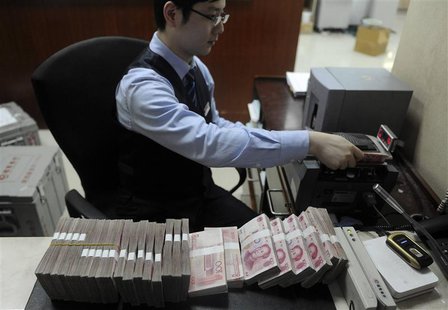 An employee counts 100 Chinese yuan banknotes at a bank in Hefei, Anhui province, January 21, 2013. Yield-chasing investors, whose hunger fo An employee counts 100 Chinese yuan banknotes at a bank in Hefei, Anhui province, January 21, 2013. Yield-chasing investors, whose hunger fo