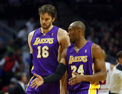 Los Angeles Lakers power forward Pau Gasol (L) listens to Los Angeles Lakers shooting guard Kobe Bryant (R) during the first half of their N Los Angeles Lakers power forward Pau Gasol (L) listens to Los Angeles Lakers shooting guard Kobe Bryant (R) during the first half of their N