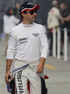 Marussia Formula One driver Timo Glock of Germany walks in the pit lane before the first practice session of the Indian F1 Grand Prix at the Marussia Formula One driver Timo Glock of Germany walks in the pit lane before the first practice session of the Indian F1 Grand Prix at the