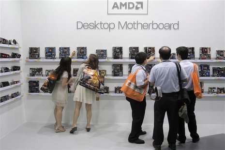 Visitors look at motherboards being displayed at the AMD booth during the 2012 Computex exhibition at the TWTC Nangang exhibition hall in Ta Visitors look at motherboards being displayed at the AMD booth during the 2012 Computex exhibition at the TWTC Nangang exhibition hall in Ta
