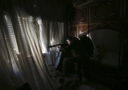 A fighter from the Sadik unit of Free Syrian Army's Tahrir al Sham brigade takes aim at Syrian soldiers position from a house in Mleha subur A fighter from the Sadik unit of Free Syrian Army's Tahrir al Sham brigade takes aim at Syrian soldiers position from a house in Mleha subur
