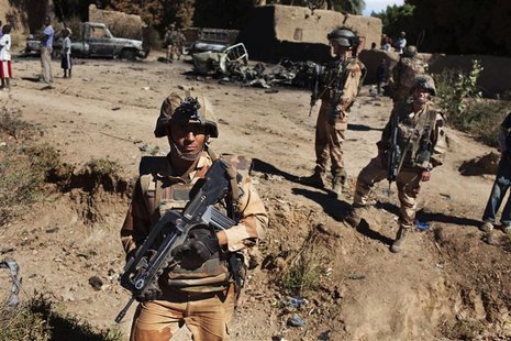 French soldiers stand guard in front of charred pickup trucks in Diabaly, Mali, January 21, 2013. REUTERS/Joe Penney French soldiers stand guard in front of charred pickup trucks in Diabaly, Mali, January 21, 2013. REUTERS/Joe Penney