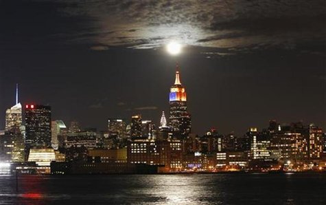 A full moon rises behind the Empire State Building and the skyline of New York, as seen from a park along the Hudson River in Hoboken, New J A full moon rises behind the Empire State Building and the skyline of New York, as seen from a park along the Hudson River in Hoboken, New J