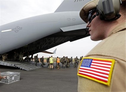 A U.S. soldier looks on as French soldiers leave a U.S. Air Force C-17 transport plane in Bamako January 22, 2013. The United States has sta A U.S. soldier looks on as French soldiers leave a U.S. Air Force C-17 transport plane in Bamako January 22, 2013. The United States has sta
