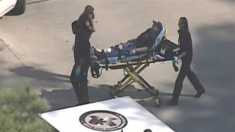 Police and emergency personnel evacuate an injured male on a stretcher outside a building on the Lone Star College Campus near Houston, Texa Police and emergency personnel evacuate an injured male on a stretcher outside a building on the Lone Star College Campus near Houston, Texa