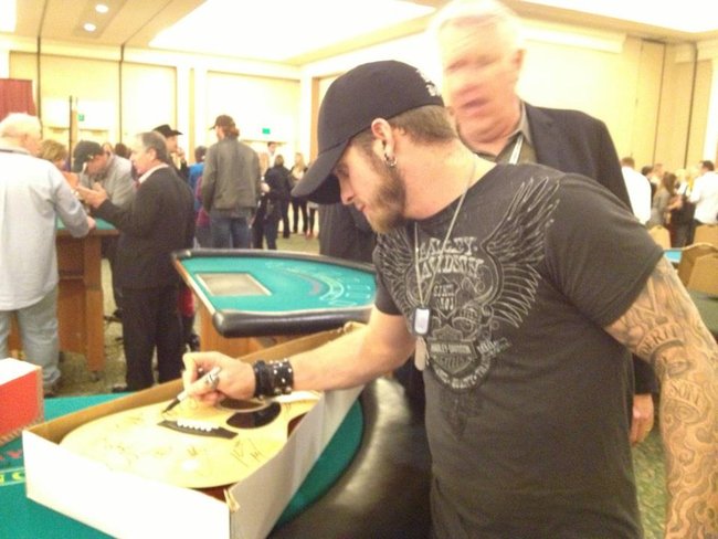Brantley Gilbert signing the guitar Jess Kelley won for the St. Jude Radiothon. Thanks Brantley!