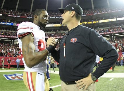San Francisco 49ers wide receiver Randy Moss (L) shakes hands with head coach Jim Harbaugh after the 49ers defeated the Atlanta Falcons to w San Francisco 49ers wide receiver Randy Moss (L) shakes hands with head coach Jim Harbaugh after the 49ers defeated the Atlanta Falcons to w