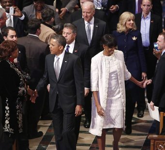 Attendees greet U.S. President Barack Obama and his wife Michelle as they arrive for the Presidential Inaugural Prayer Service at the Nation Attendees greet U.S. President Barack Obama and his wife Michelle as they arrive for the Presidential Inaugural Prayer Service at the Nation