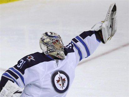 Winnipeg Jets' goalie Ondrej Pavelec makes a save against the Washington Capitals in the third period of their NHL hockey game in Washington Winnipeg Jets' goalie Ondrej Pavelec makes a save against the Washington Capitals in the third period of their NHL hockey game in Washington