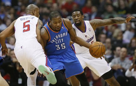 Oklahoma City Thunder's Kevin Durant (C) is fouled by Los Angeles Clippers Caron Butler (L) as the Clippers DeAndre Jordan looks on during t Oklahoma City Thunder's Kevin Durant (C) is fouled by Los Angeles Clippers Caron Butler (L) as the Clippers DeAndre Jordan looks on during t