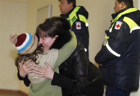 A woman hugs her daughter, who was a passenger on a Russian Emergencies Ministry flight from Beirut, after her arrival at Moscow's Domodedov A woman hugs her daughter, who was a passenger on a Russian Emergencies Ministry flight from Beirut, after her arrival at Moscow's Domodedov