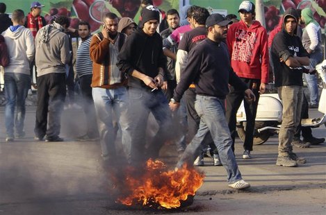 Ultras soccer fans gather around tyres they burnt over a bridge during a rally to demand justice for 74 people killed in a stadium stampede Ultras soccer fans gather around tyres they burnt over a bridge during a rally to demand justice for 74 people killed in a stadium stampede