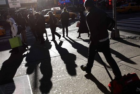 People walk in the late afternoon sun through Times Square in New York January 22, 2013. REUTERS/Carlo Allegri People walk in the late afternoon sun through Times Square in New York January 22, 2013. REUTERS/Carlo Allegri