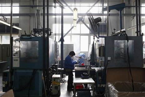 A worker examines a product at a plastics factory on the outskirts of Shanghai December 14, 2012. REUTER/Aly Song A worker examines a product at a plastics factory on the outskirts of Shanghai December 14, 2012. REUTER/Aly Song
