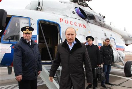 Russian President Vladimir Putin (C) arrives at the town of Krymsk in the Krasnodar region January 11, 2013. REUTERS/Mikhail Klimentyev/RIA Russian President Vladimir Putin (C) arrives at the town of Krymsk in the Krasnodar region January 11, 2013. REUTERS/Mikhail Klimentyev/RIA