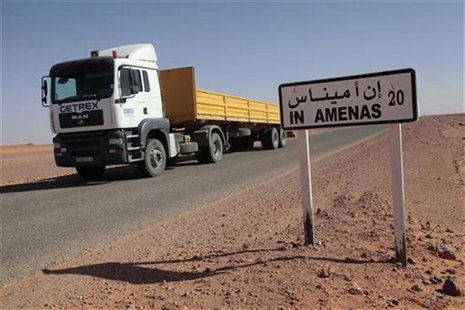 A truck passes by a road sign indicating In Amenas, about 100 km (60 miles) from the Algerian and Libyan border, where Islamist militants we A truck passes by a road sign indicating In Amenas, about 100 km (60 miles) from the Algerian and Libyan border, where Islamist militants we