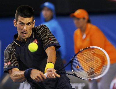 Novak Djokovic of Serbia hits a return to David Ferrer of Spain during their men's singles semi-final match at the Australian Open tennis to Novak Djokovic of Serbia hits a return to David Ferrer of Spain during their men's singles semi-final match at the Australian Open tennis to