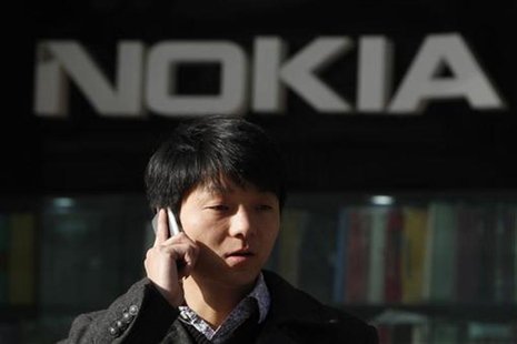 A man using his mobile phone walks under a Nokia logo in Shanghai December 6, 2012. REUTERS/Aly Song A man using his mobile phone walks under a Nokia logo in Shanghai December 6, 2012. REUTERS/Aly Song