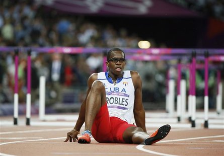 Cuba's Dayron Robles sits on the track after he suffered an injury during the men's 110m hurdles final during the London 2012 Olympics Games Cuba's Dayron Robles sits on the track after he suffered an injury during the men's 110m hurdles final during the London 2012 Olympics Games