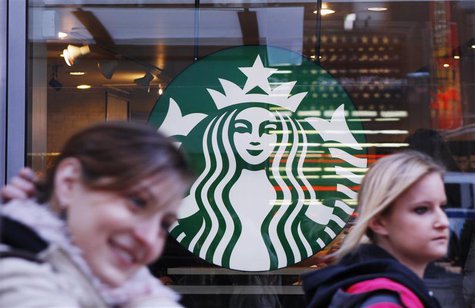Pedestrians walk past the new Starbucks logo on a store in Times Square in New York March 8, 2011. REUTERS/Lucas Jackson Pedestrians walk past the new Starbucks logo on a store in Times Square in New York March 8, 2011. REUTERS/Lucas Jackson
