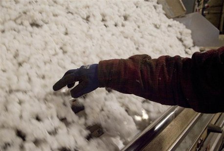 A Gin operator checks on the ginning process in Minturn, South Carolina in this November 27, 2012, file photo. The global cotton trade, whic A Gin operator checks on the ginning process in Minturn, South Carolina in this November 27, 2012, file photo. The global cotton trade, whic