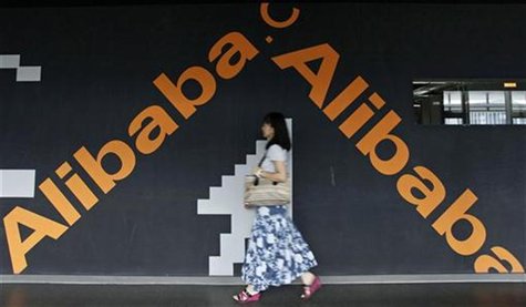 An employee walks past a wall painted with the logo of Alibaba (China) Technology Co. Ltd at its headquarters office on the outskirts of Han An employee walks past a wall painted with the logo of Alibaba (China) Technology Co. Ltd at its headquarters office on the outskirts of Han