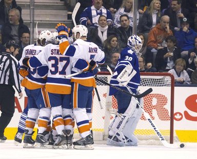 The New York Islanders celebrate next to Toronto Maple Leafs' goalie Ben Scrivens after Islanders Brad Boyes scored in the second period of The New York Islanders celebrate next to Toronto Maple Leafs' goalie Ben Scrivens after Islanders Brad Boyes scored in the second period of
